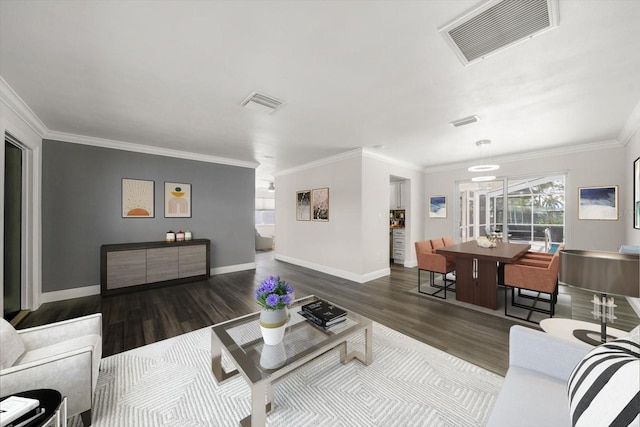 living room with dark hardwood / wood-style floors and crown molding