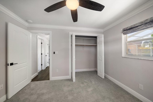 unfurnished bedroom with a closet, dark carpet, ceiling fan, and ornamental molding