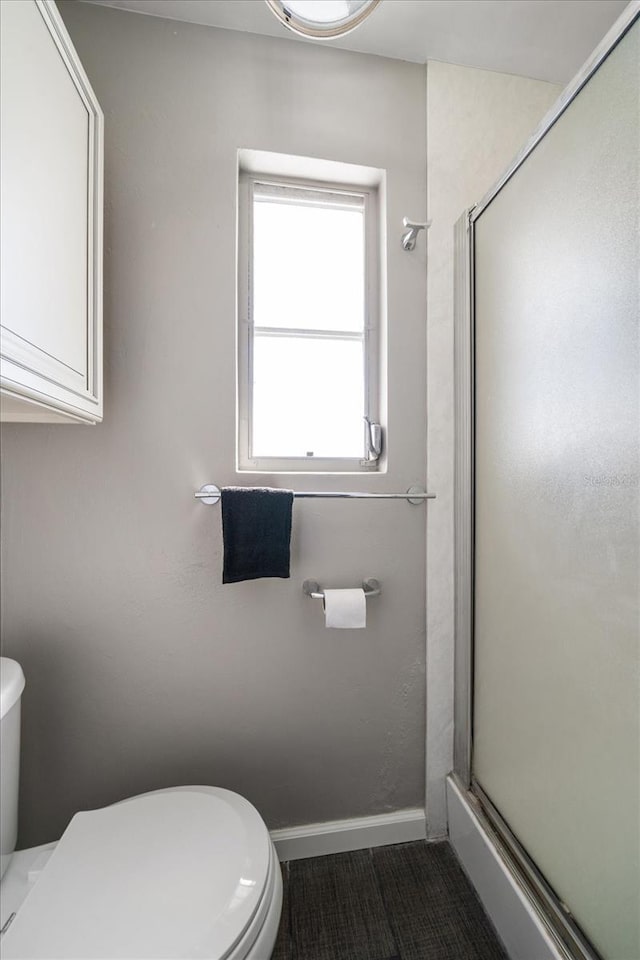 bathroom with toilet and walk in shower