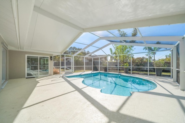 view of pool featuring a patio area and glass enclosure