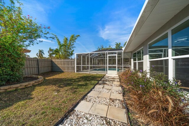 13632 Imperial Groves Dr S, Largo, FL 33774 - fenced backyard featuring a lanai and a patio