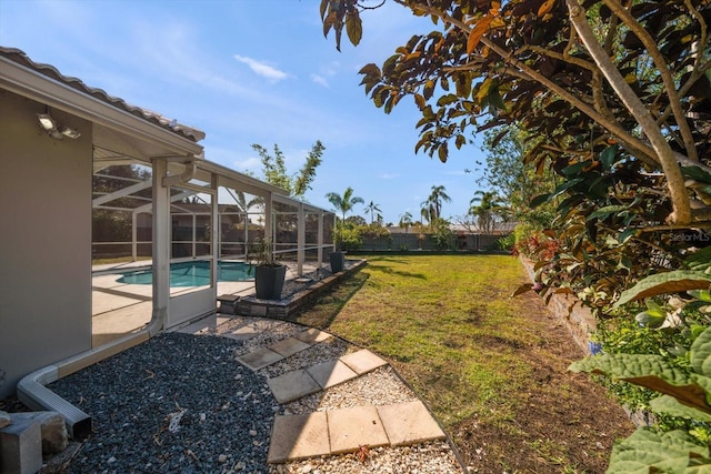 view of yard featuring a patio and a lanai