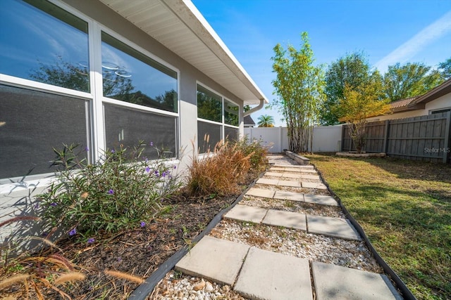 view of side of home with a lawn