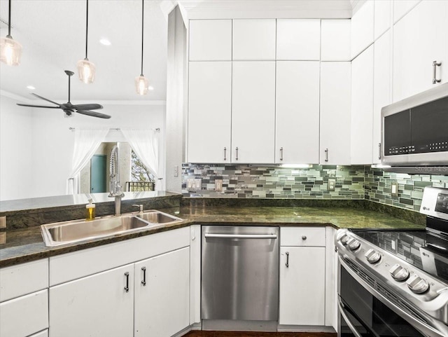 kitchen featuring stainless steel appliances, ceiling fan, sink, decorative light fixtures, and white cabinetry