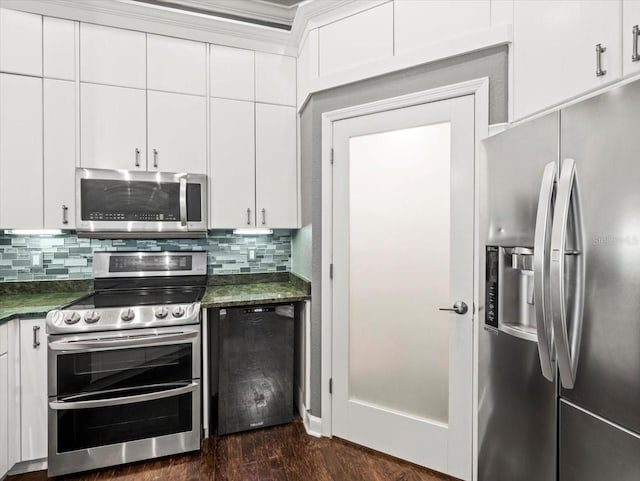 kitchen with stainless steel appliances, dark hardwood / wood-style flooring, dark stone counters, decorative backsplash, and white cabinets