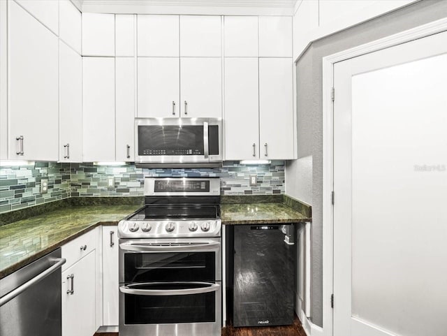 kitchen featuring dark stone counters, white cabinets, stainless steel appliances, and dark hardwood / wood-style floors