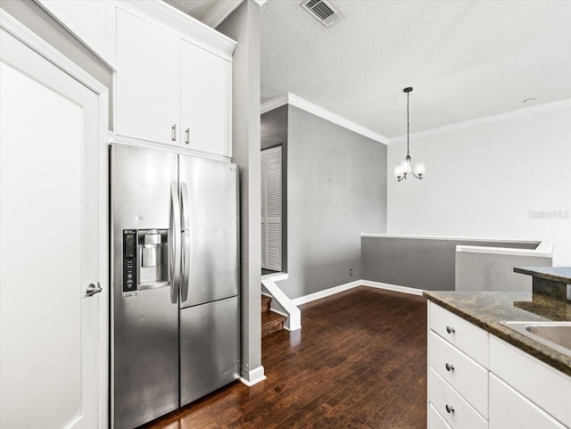 kitchen featuring white cabinetry, stainless steel fridge, dark hardwood / wood-style flooring, and decorative light fixtures