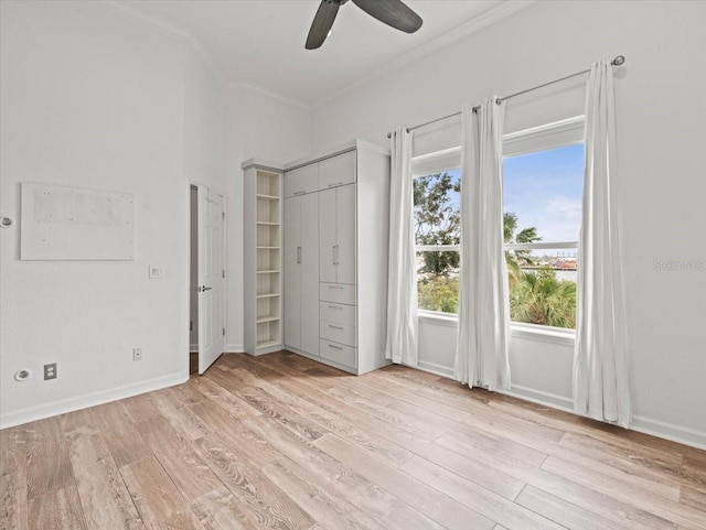 unfurnished bedroom featuring ceiling fan, light hardwood / wood-style flooring, and crown molding