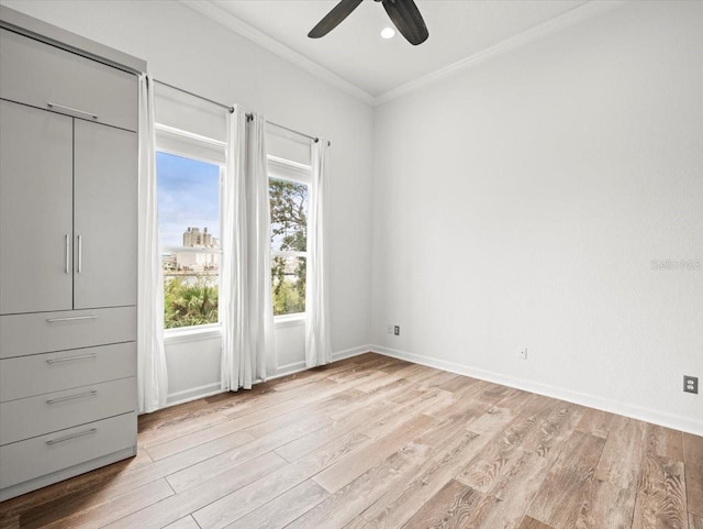 unfurnished bedroom with ceiling fan, crown molding, and light hardwood / wood-style flooring