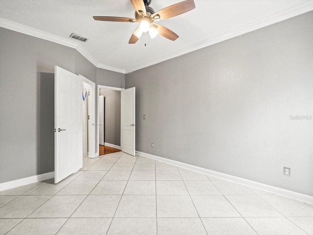 unfurnished bedroom with ceiling fan, light tile patterned flooring, and ornamental molding