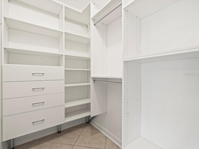 spacious closet with light tile patterned floors