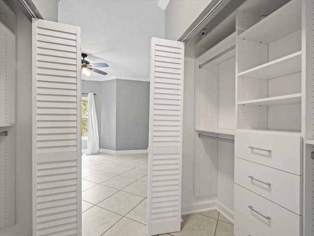 walk in closet featuring ceiling fan and light tile patterned floors