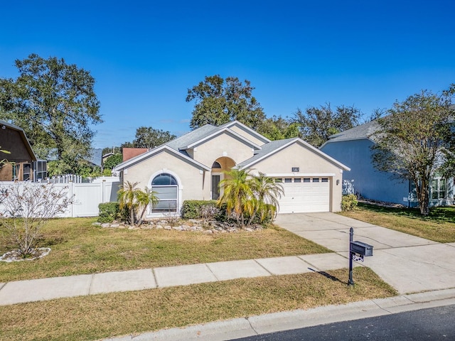 ranch-style home with a garage and a front lawn