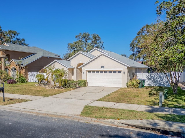 view of front of property featuring a front yard and a garage