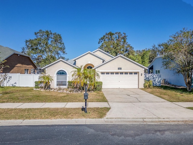 view of front of home with a front yard and a garage