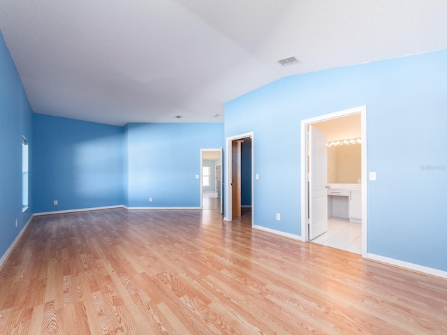 interior space featuring light hardwood / wood-style floors and vaulted ceiling