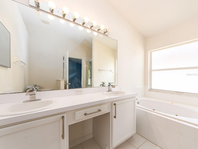 bathroom featuring tile patterned flooring, vanity, a relaxing tiled tub, and lofted ceiling