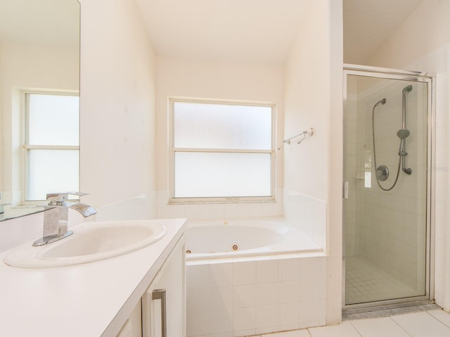 bathroom featuring vanity, tile patterned flooring, and plus walk in shower