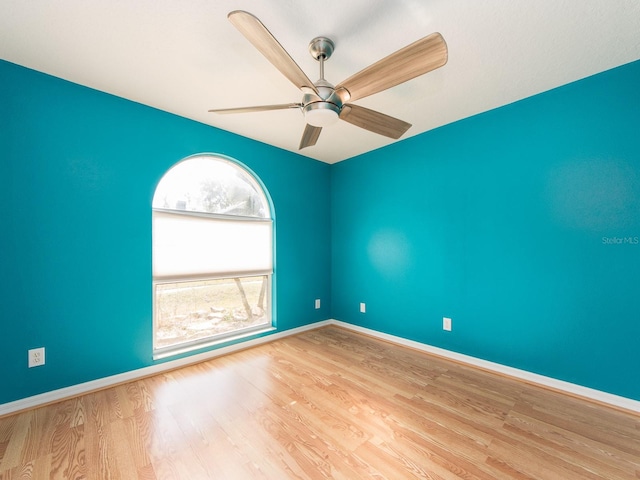 unfurnished room with ceiling fan and light wood-type flooring