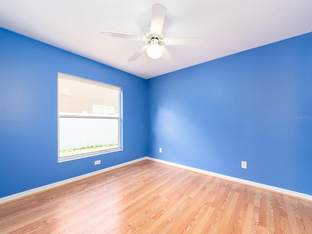 spare room featuring light wood-type flooring and ceiling fan