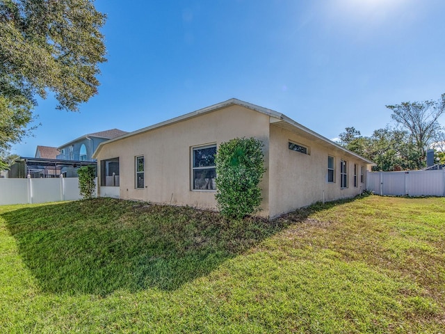 view of property exterior with a lawn