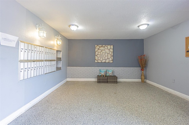 1900 68th St N Unit 301, Saint Petersburg, FL 33710 - carpeted spare room featuring a textured ceiling, baseboards, and mail area