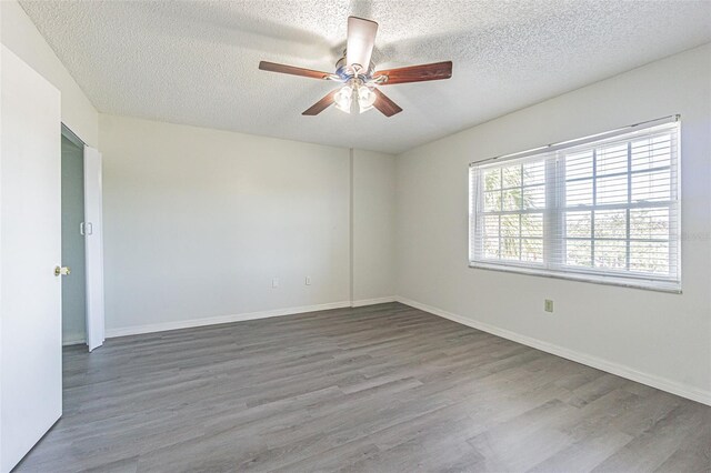 empty room featuring wood-type flooring, a textured ceiling, and ceiling fan