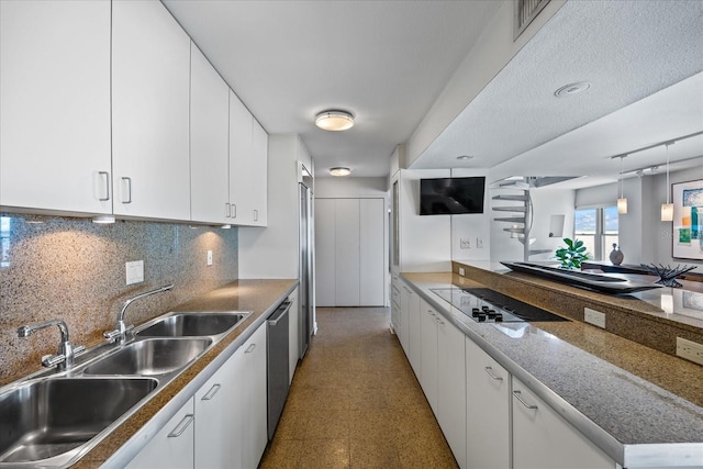 kitchen with white cabinets, black electric stovetop, and sink