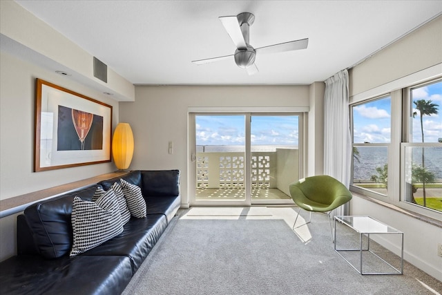 carpeted living room featuring ceiling fan