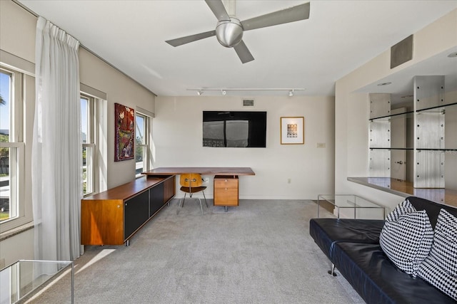 carpeted living room with ceiling fan and track lighting