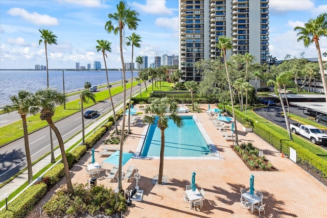 view of pool featuring a patio area and a water view