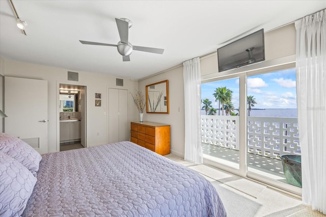 bedroom with ceiling fan, access to exterior, and ensuite bath