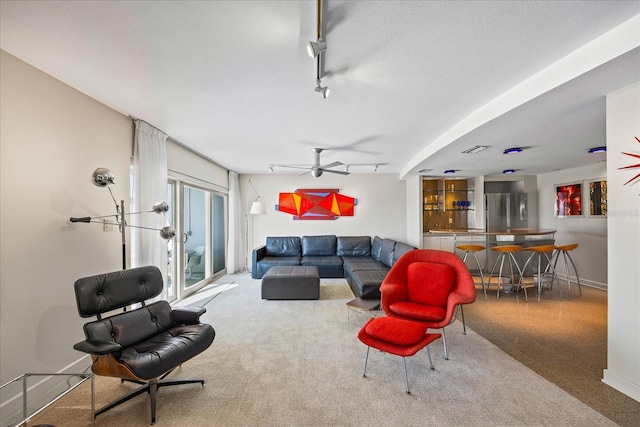 living room with ceiling fan and rail lighting