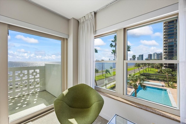 interior space with a city view, a healthy amount of sunlight, and a water view