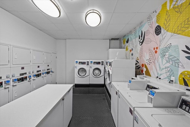 shared laundry area featuring washing machine and clothes dryer and stacked washer / dryer