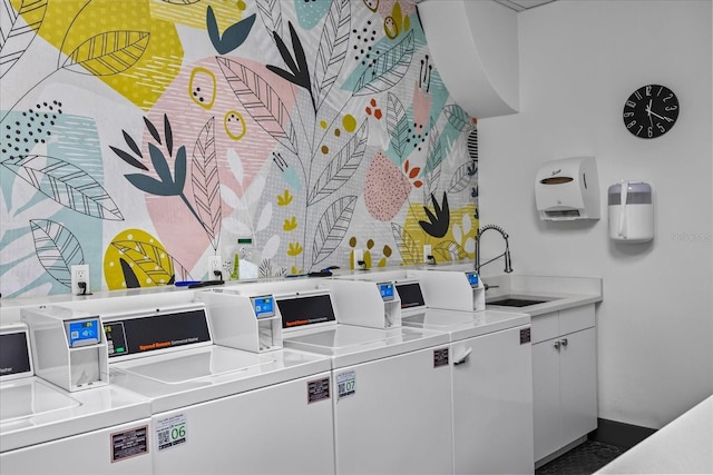 community laundry room with independent washer and dryer and a sink