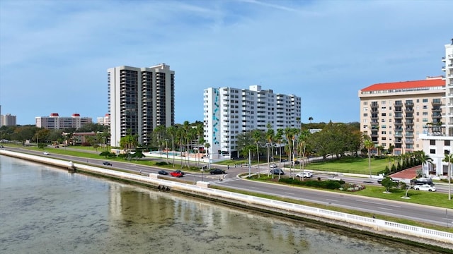exterior space with a city view and a water view