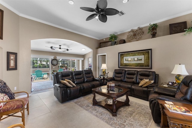 tiled living room with vaulted ceiling, ceiling fan, and ornamental molding