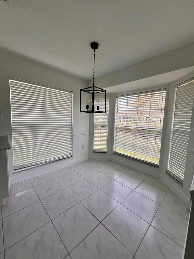 unfurnished dining area featuring a notable chandelier