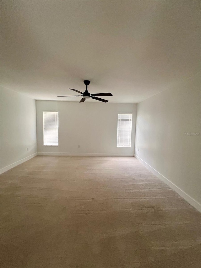 spare room with light carpet and ceiling fan