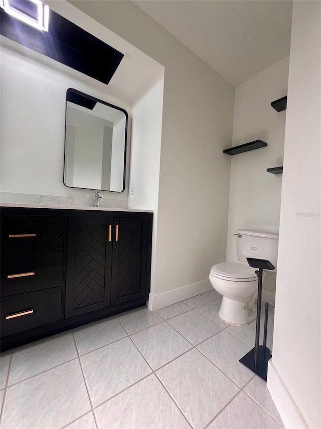 bathroom featuring tile patterned flooring, vanity, and toilet