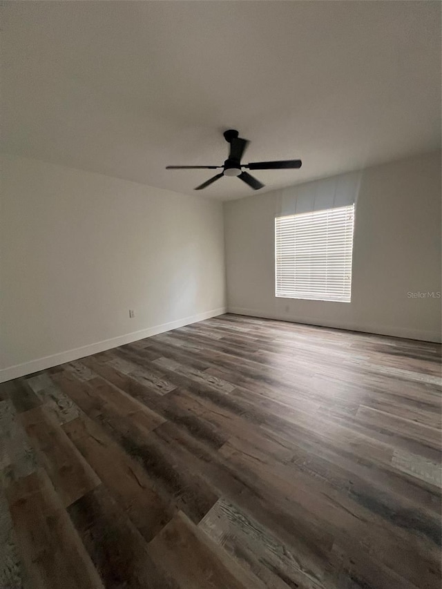 spare room featuring ceiling fan and dark hardwood / wood-style flooring