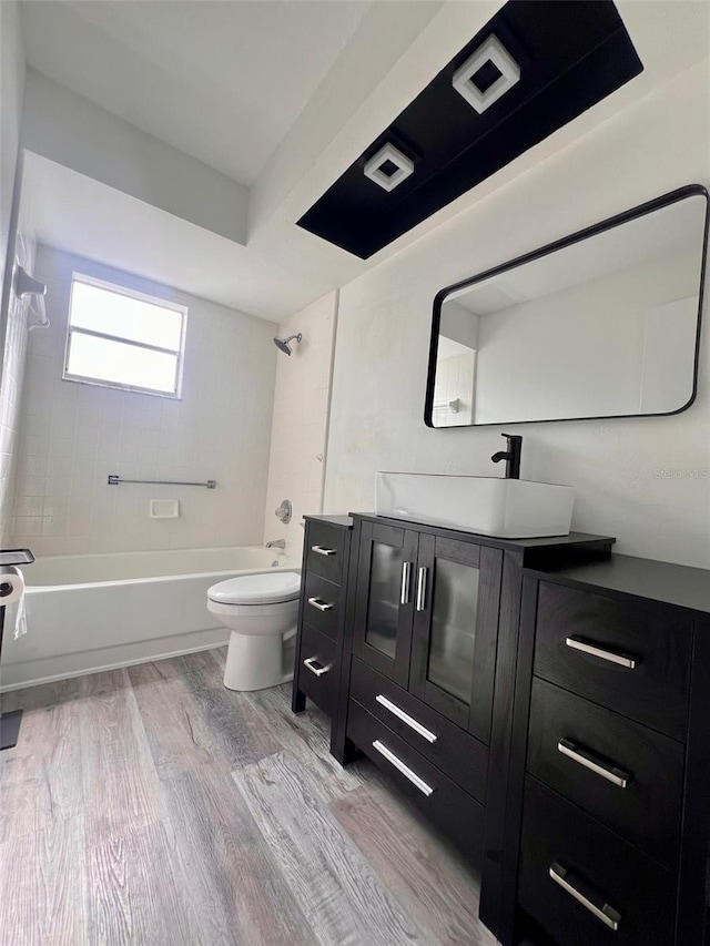 full bathroom with hardwood / wood-style flooring, vanity, toilet, and bathing tub / shower combination