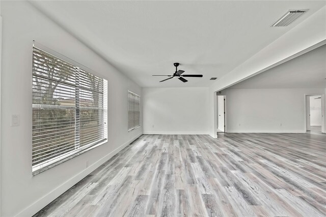 unfurnished living room featuring light hardwood / wood-style flooring and ceiling fan