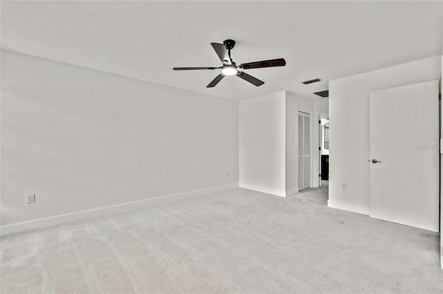 carpeted empty room featuring ceiling fan