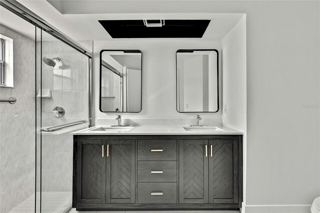 bathroom featuring an enclosed shower and vanity