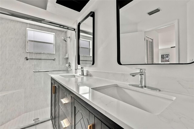 bathroom with vanity and a shower with shower door