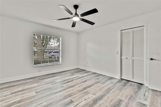 unfurnished bedroom with a closet, ceiling fan, and light wood-type flooring