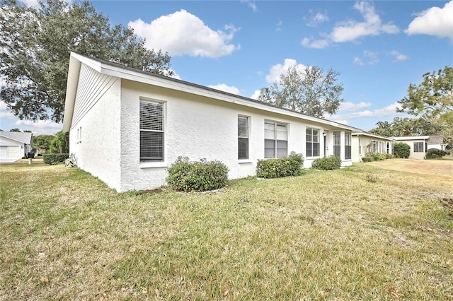 rear view of property with a lawn