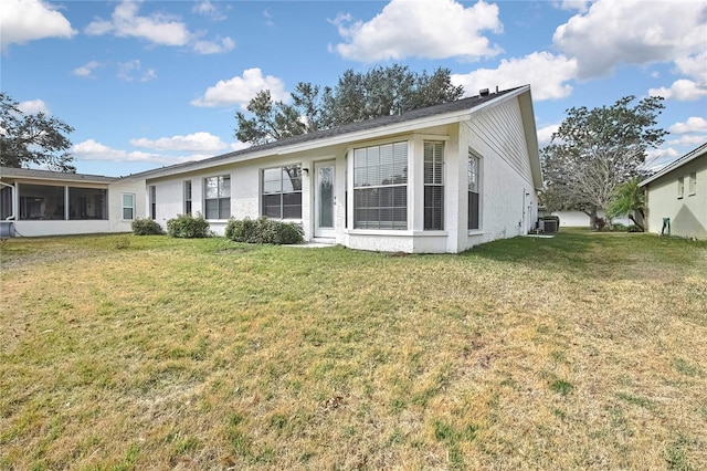 view of front of home featuring cooling unit and a front lawn